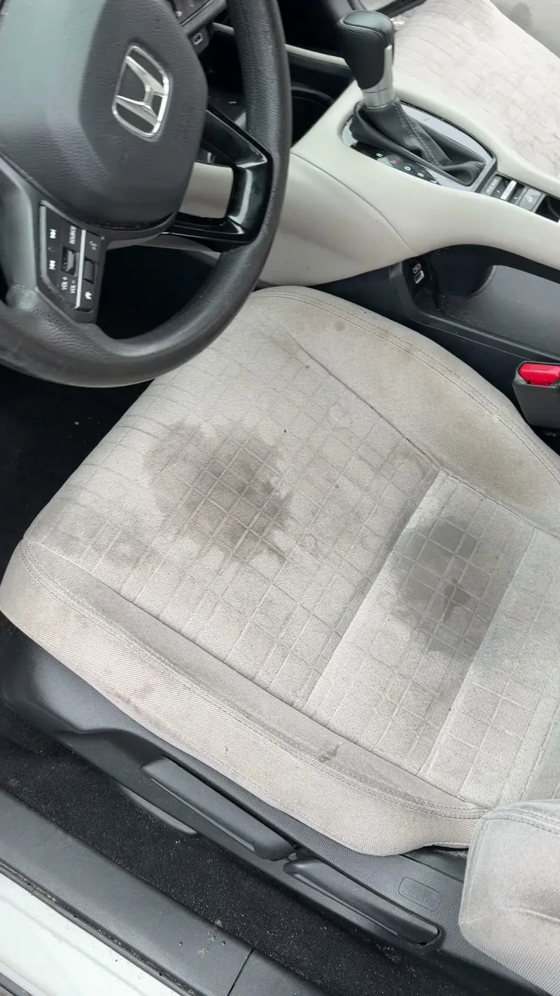 Stained seat upholstery before detailing